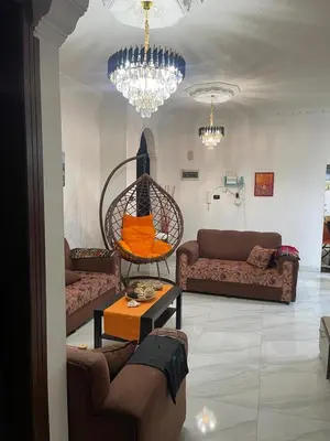 a living room with couches and a couch and a table at Samar Home in Amman