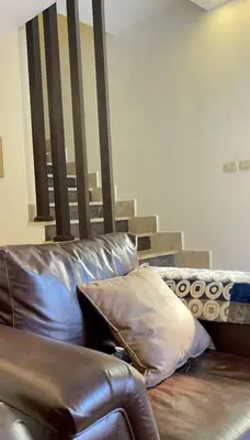 a leather couch with two pillows on top of it at Private Pool - Relax Chalet Deadsea in Amman