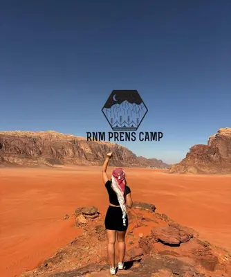 a woman standing on a rock in the desert at Rum prens camp in Wadi Rum