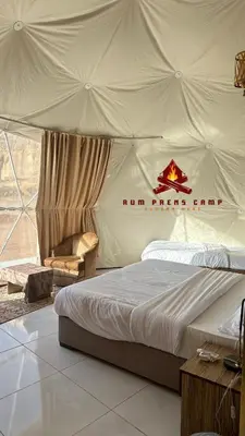 a bedroom with a tent with a bed and a chair at Rum prens camp in Wadi Rum