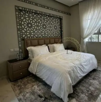 a bedroom with a large bed and a window at sweetsoul in Amman