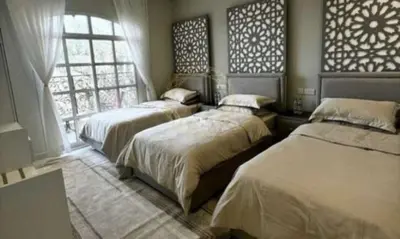 a bedroom with two beds and a window at sweetsoul in Amman