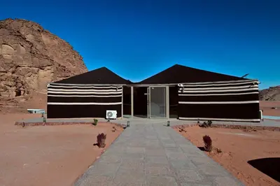 a black and white building in the desert at Mars Land Luxury Camp in Wadi Rum