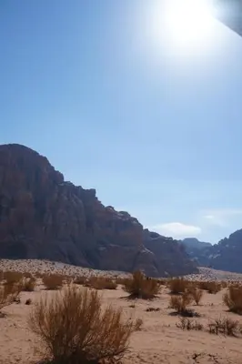 a view of the desert with mountains in the background at Bedouin cave wadi rum campsite in Wadi Rum