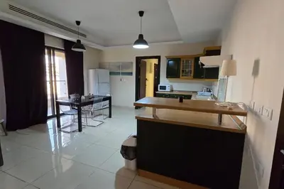 a kitchen with a counter and a table in it at Apartment the most upscale neighborhoods of Amman in Amman