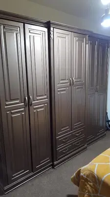 a row of wooden closets in a bedroom at شقة مفروشة مجهزة بكل الخدمات in Irbid