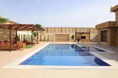 a swimming pool in the middle of a house at Sunrise Villa in Sowayma