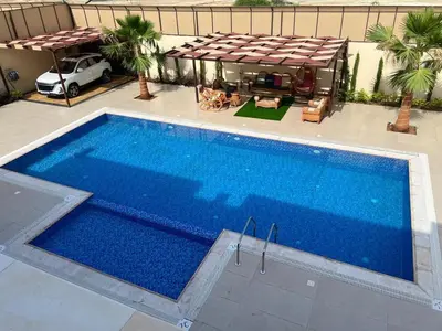 an overhead view of a large blue swimming pool at Sunrise Villa in Sowayma