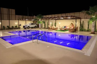 a large swimming pool with blue lights in a building at Sunrise Villa in Sowayma