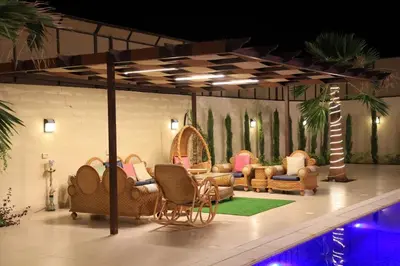 a group of chairs and tables on a stage at Sunrise Villa in Sowayma