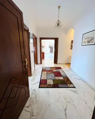 a hallway with a door and a tile floor at Furnished Apartment for Rent in Abdoun 200sqm in Amman