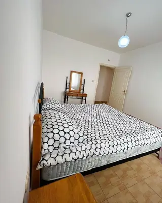 a bedroom with a bed and a chair at Furnished Apartment for Rent in Abdoun 200sqm in Amman