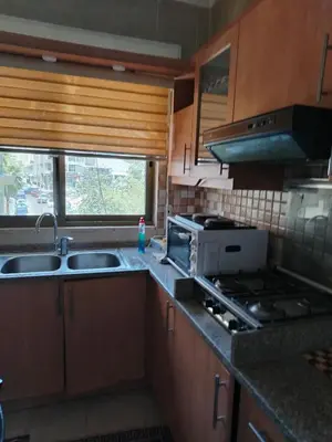 a kitchen with a sink and a stove at شقة مفروشة الدوار السابع خلف كوزمو in Amman