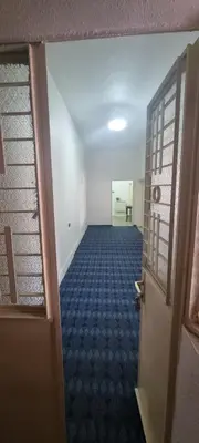 an empty room with a door and a hallway at Nights of the Orient Guesthouse in Al Salt