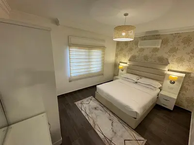 a small bedroom with a bed and a window at Cozy apt Grt location for long and short stay in Amman