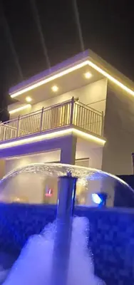 a building with a swimming pool in front of a house at منتجع الحور in Ajloun