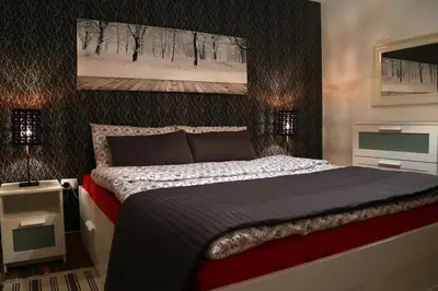 a bedroom with a large bed and two night stands at Apartment in Amman with wow furniture in Amman