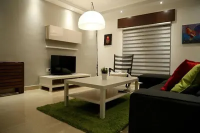 a living room with a white table and a couch at Apartment in Amman with wow furniture in Amman