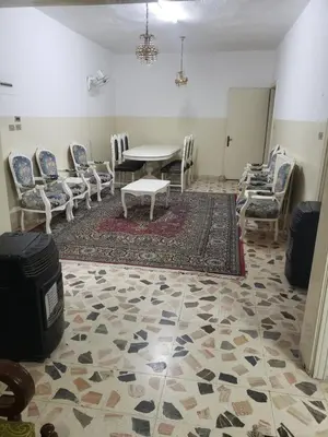 a room with a table and chairs and a rug at ALOTAIBI bulding # 6 in Amman