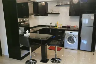 a kitchen with a sink and a washing machine at Apartment in Amman 7'th Circle in Amman