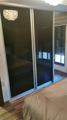 a bedroom with a large glass window with a bed at Apartment in Amman 7'th Circle in Amman