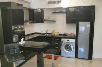 a kitchen with a washing machine and a washer at Apartment in Amman 7'th Circle in Amman