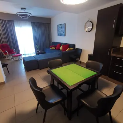 a living room with a couch and a table and chairs at E23 Luxury - Full Sea view-Samra Resort in Sowayma