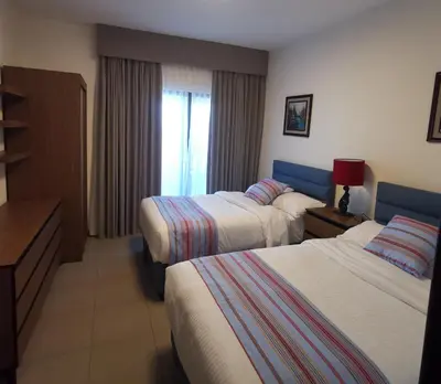 a hotel room with two beds and a window at E23 Luxury - Full Sea view-Samra Resort in Sowayma