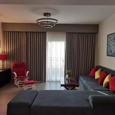 a living room with a blue couch and a red chair at E23 Luxury - Full Sea view-Samra Resort in Sowayma