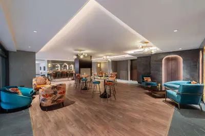 a lobby with couches and tables and chairs at Doubletree By Hilton Amman Hotel & Residences in Amman