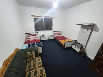 a room with two beds and a window at Artemis Hotel in Jerash