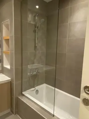 a shower with a glass door in a bathroom at Lovely 2-Bedroom with pool in the heart of Aqaba in Aqaba