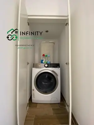 a laundry room with a washing machine in a room at Lovely 2-Bedroom with pool in the heart of Aqaba in Aqaba