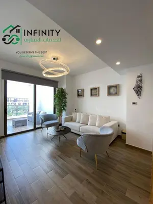 a living room with a couch and a table at Lovely 2-Bedroom with pool in the heart of Aqaba in Aqaba