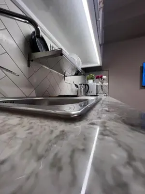 a kitchen with a stainless steel counter top at Amman Central Cozy Apartment in Amman