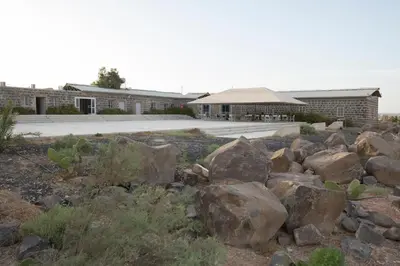 a pile of rocks in front of a building at Azraq Lodge in Al Azraq ash Shamālī