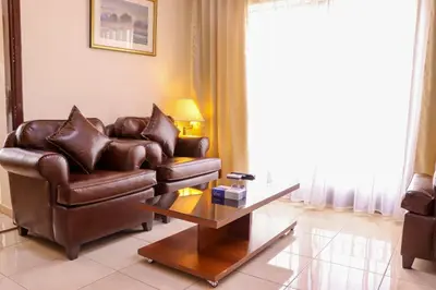 a living room with a leather couch and a coffee table at Al Jamal Suites in Amman