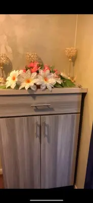 a counter with flowers on top of a cabinet at Jordan in Irbid