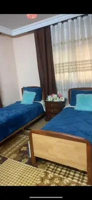 a bedroom with two beds and a window at Jordan in Irbid