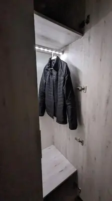 a jacket hanging on a wall in a room at Modern Flat in Heart of Amman in Amman