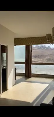 a room with a window with a view of the desert at Omar in Al Bunayyāt ash Shamālīyah