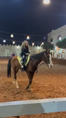 a woman riding on the back of a horse at Golden Horse Chalet And Club in Maḩaţţat al Jīzah
