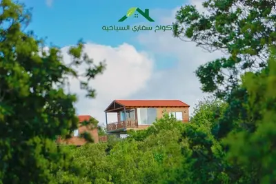 a house on top of a hill with trees at اكواخ سفاري السياحية in Ajloun