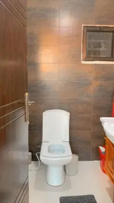 a small bathroom with a toilet and a sink at Rooftop View in Amman