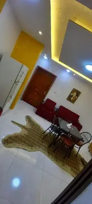 a room with a table and chairs and a large fish rug at amman citadle in Amman