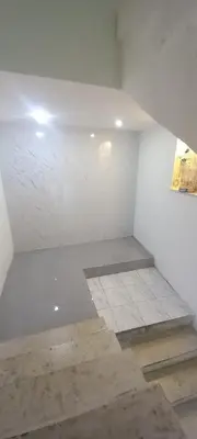 an empty room with white walls and white tile floors at amman citadle in Amman