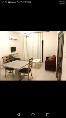 a living room with a table and a couch at في ظلال الطبيعه in Aqaba