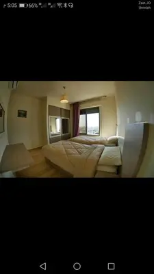 a bedroom with two beds and a window at في ظلال الطبيعه in Aqaba