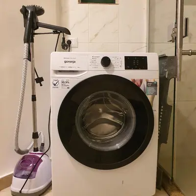 a washing machine with a vacuum next to it at Fully Equipped 3BR Apt in Family-Friendly Building in Amman