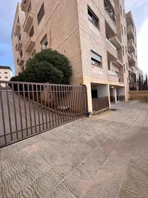 a building with a fence in front of it at كريستال in Amman